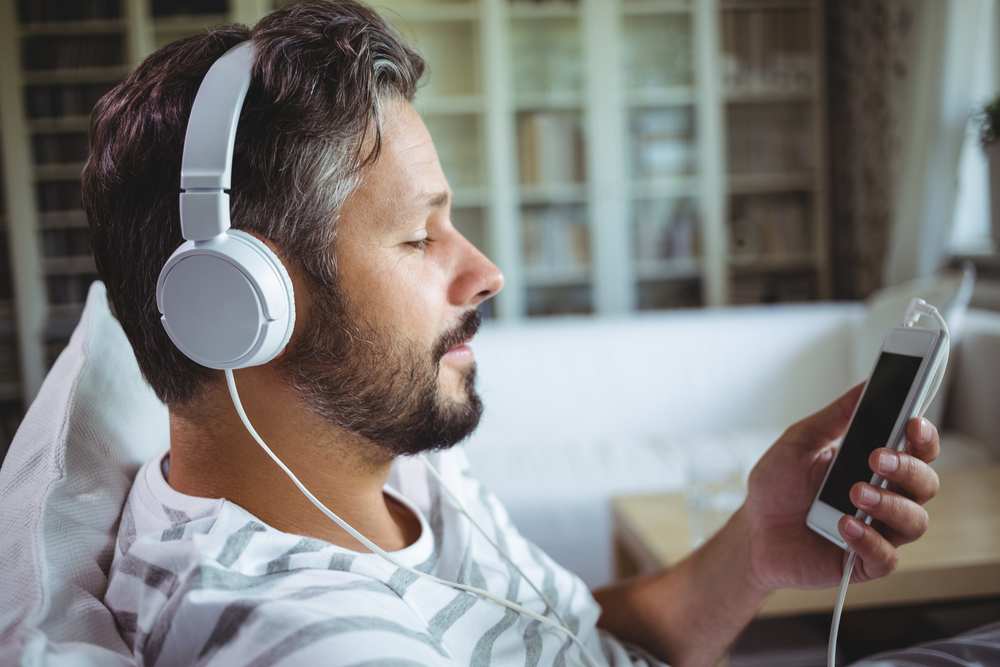 man surfing on mobile with headphones